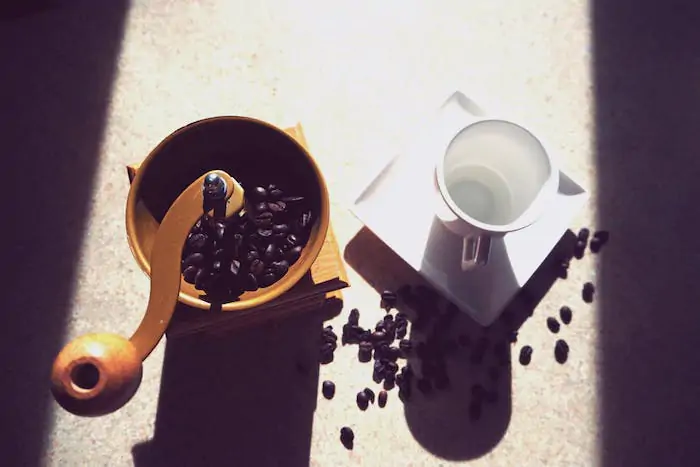 coffee grinder and a cup