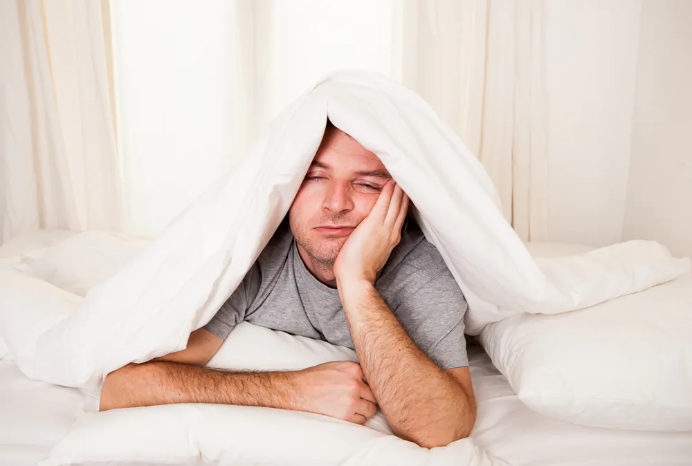 what tea helps you sleep - man having trouble sleeping