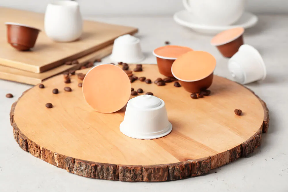 A cup of Nespresso coffee in the middle of coffee pods - Can you reuse coffee pods