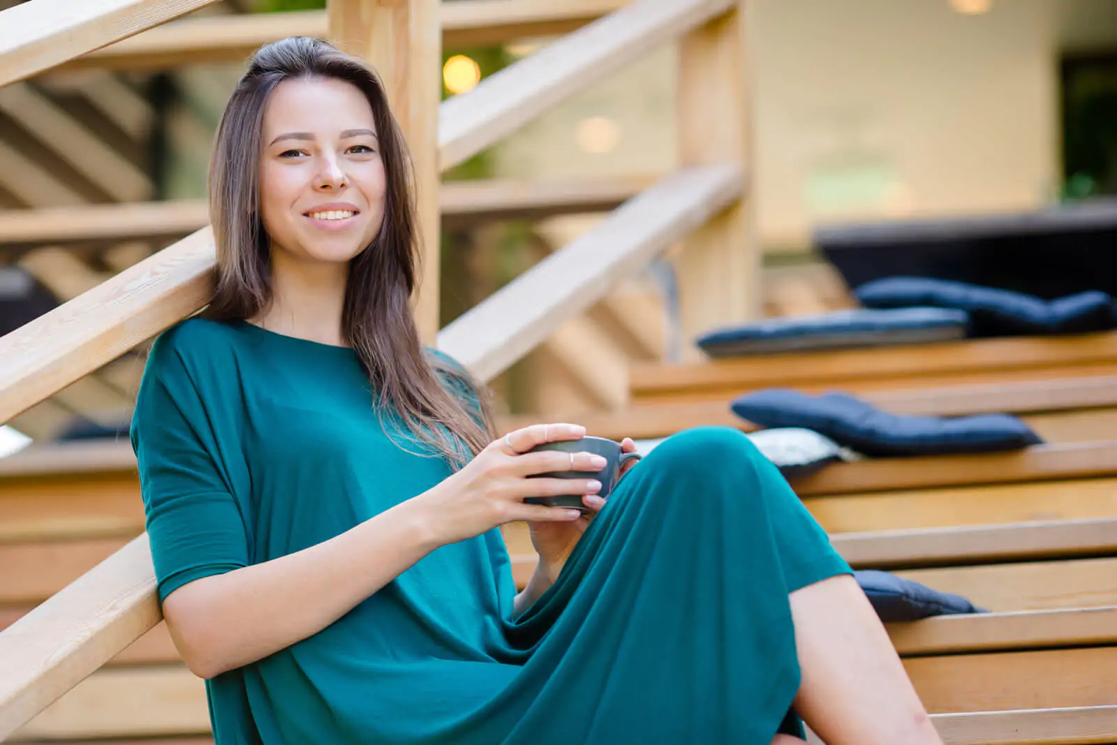 Beautiful elegant girl having breakfast and coffee at outdoor cafe
