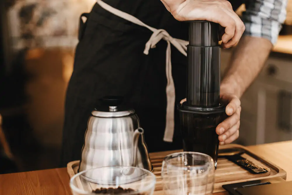 Best coffee for your aeropress. A barista preparing coffee using an aeropress.