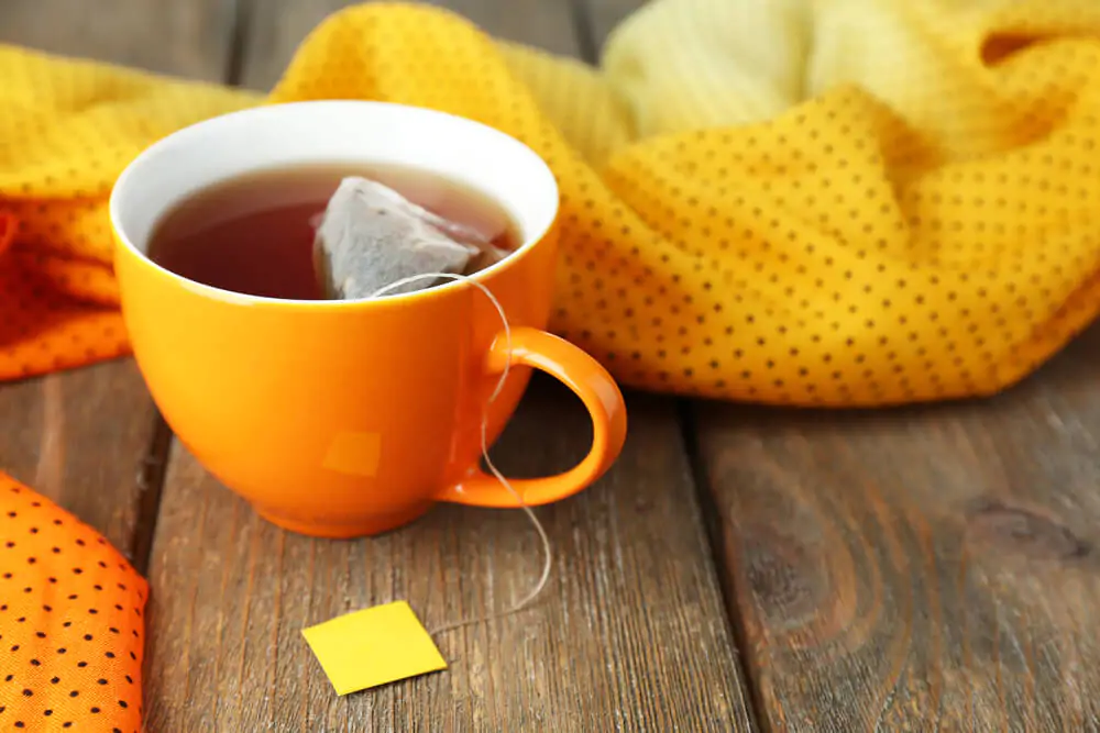 a cup of tea in a orange cup - what is numi tea