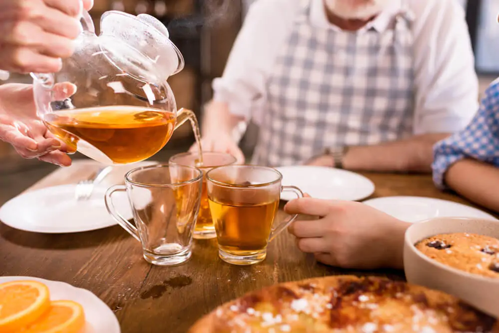 Family drinking tea at home