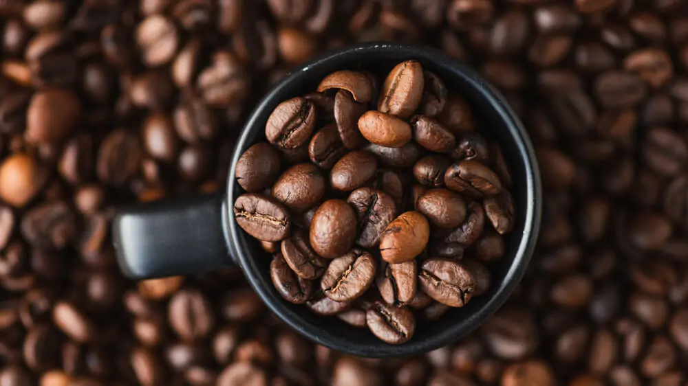 a mug full of coffee beans