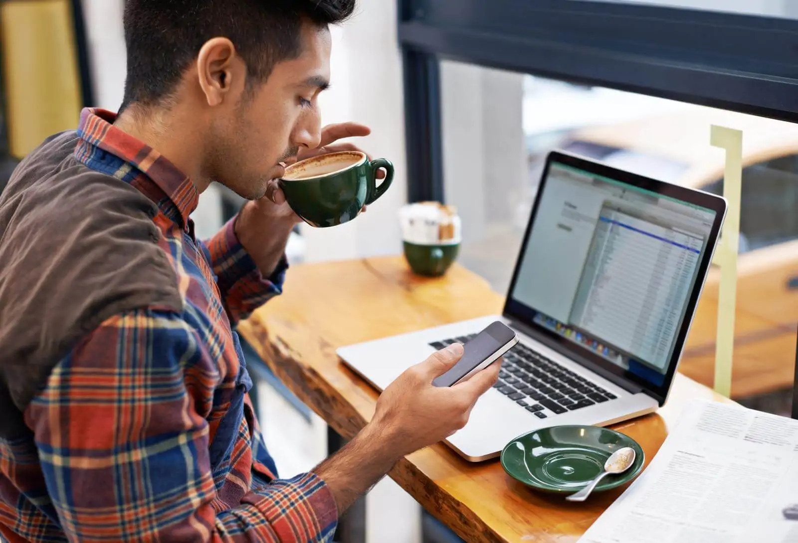 a young man working in a coffee shop - best accounting software for a coffee shop