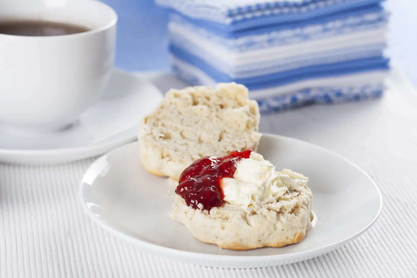 Scone with clotted cream and strawberry jam - Devon cream tea